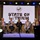 Five panelists sit on a stage in front of a large screen that reads “State of Lithium” with a battery icon.